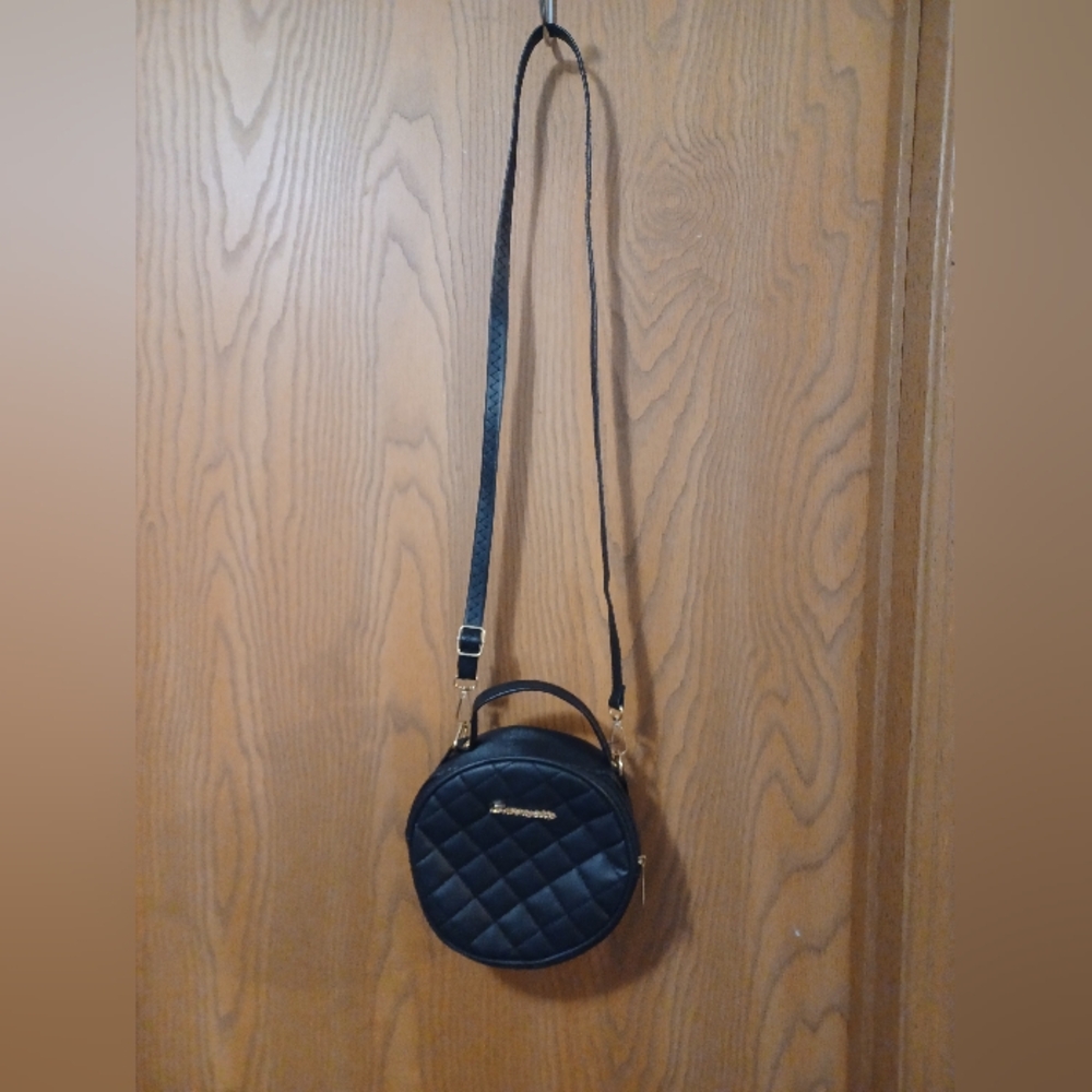 Small black quilted circular shoulder bag